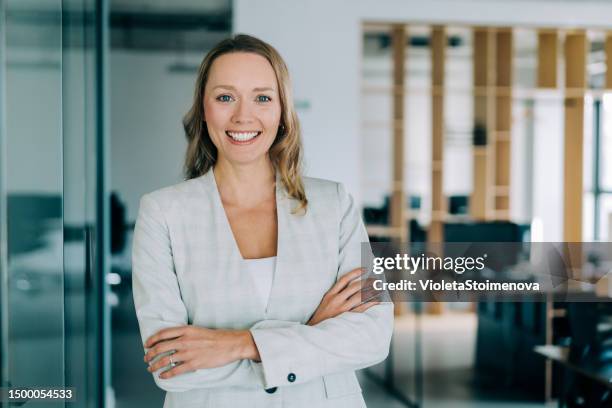 confident businesswoman in modern office. - marketing director stock pictures, royalty-free photos & images