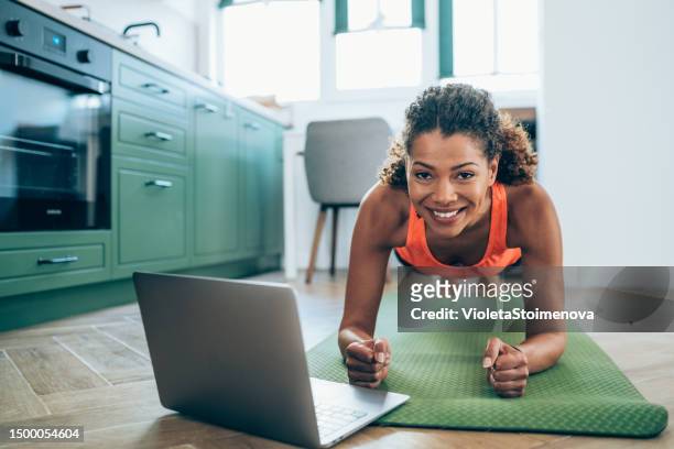 sporty woman exercising at home. - woman press ups stock pictures, royalty-free photos & images