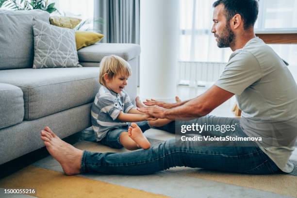 father and little son at home. - barefoot child stock pictures, royalty-free photos & images