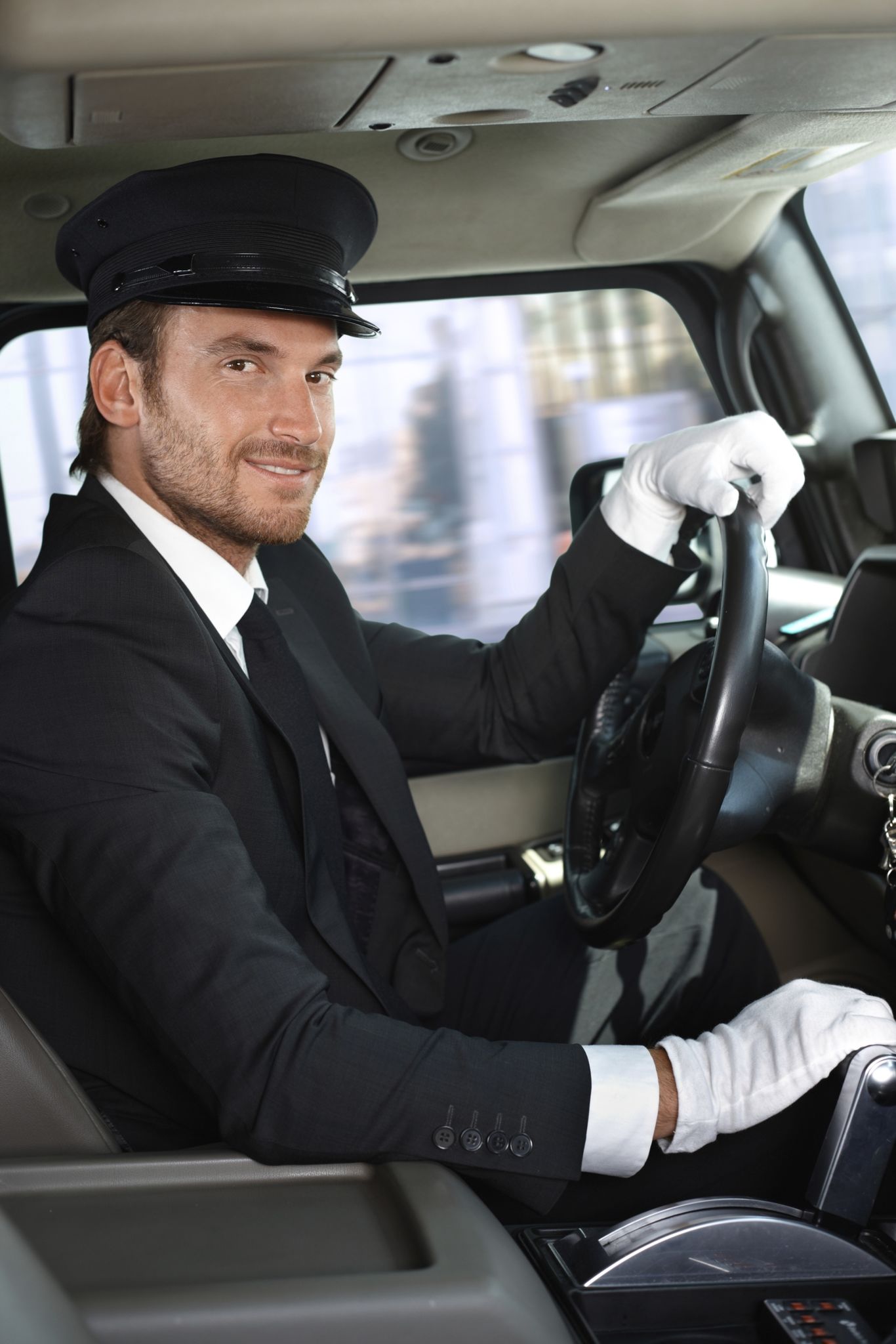 Young chauffeur in limousine smiling Young chauffeur in limousine smiling