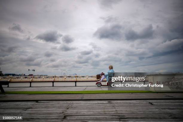 People enjoy Blackpool's iconic North Pier as the Lancashire seaside resort gears up for the Summer holidays on June 20, 2023 in Blackpool, England.