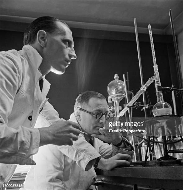 From left, Doctor Frank Curd and Doctor Frank Rose at work in a laboratory on the synthesis of a new anti-malarial drug Paludrine at the Medical...