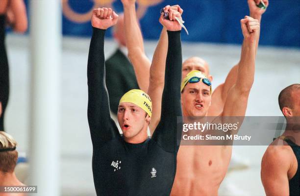 Ian Thorpe and Chris Fydler of Australia celebrate after winning the Mens 4x100 freestyle relay during the Olympics at the Sydney International...