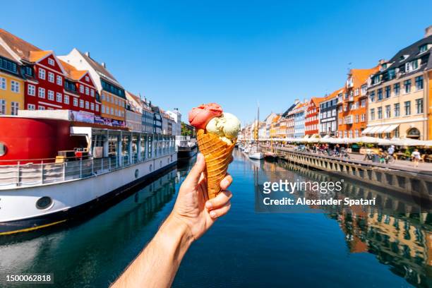 man eating ice cream at nyhavn harbour, personal perspective view, copenhagen, denmark - copenhagen food stock pictures, royalty-free photos & images