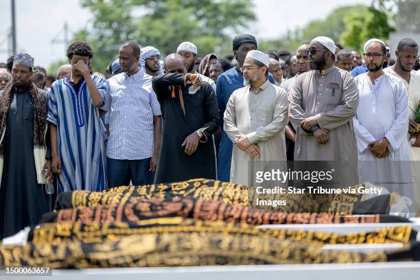 Men mourn the bodies of the five women killed in a car crash on Lake Street, during the funeral at the Dar Al-Farooq Islamic Center in Bloomington,...