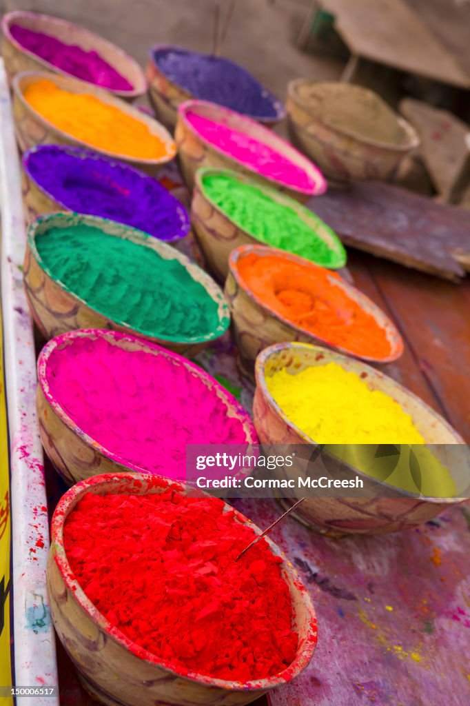 Collection of bright coloured powders for use in the making of Bindi's, taken at stall in Pushkar, Rajasthan, India
