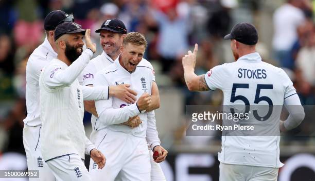 Joe Root of England is congratulated by James Anderson, Ben Stokes and Moeen Ali of England after taking the wicket of Alex Carey of Australia,...