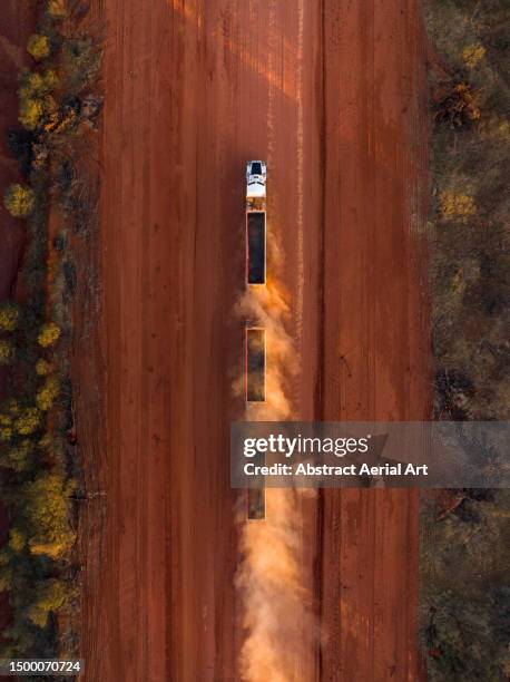 drone shot looking down on a road train driving on the tanami road, northern territory, australia - car point of view stock pictures, royalty-free photos & images