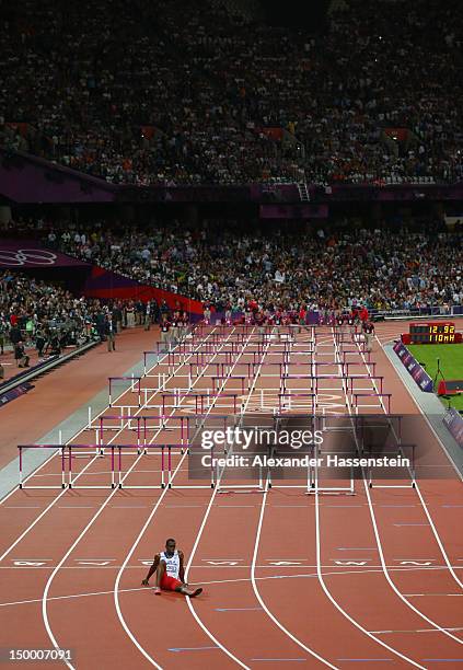 Dayron Robles of Cuba sits on the track after pulling up injured in the Men's 110m Hurdles Final on Day 12 of the London 2012 Olympic Games at...