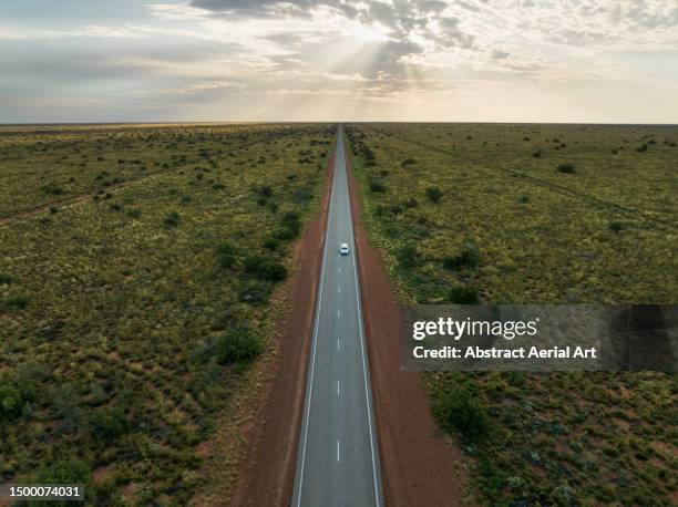 aerial image showing a camper van driving through the australian outback on a highway, western australia, australia - western australia road stock pictures, royalty-free photos & images