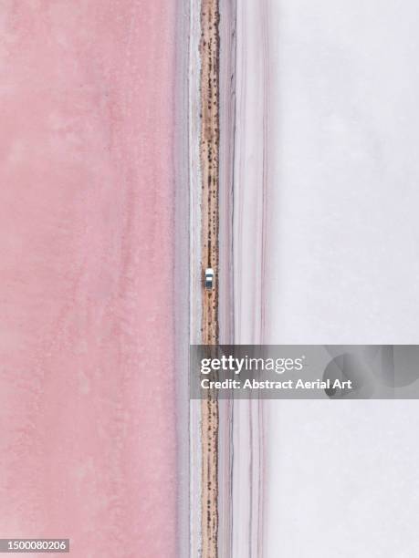 majestic shot showing a 4x4 driving across a dirt road in between salt lakes, south australia, australia - side by side comparison stock pictures, royalty-free photos & images