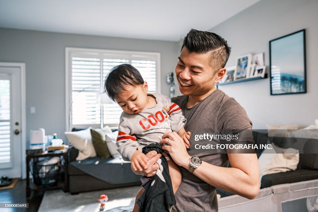 Young Korean Father at Home playing with toddler son