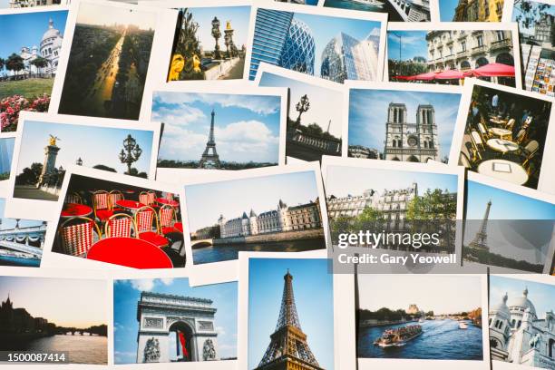 collection of instant travel holiday photos of paris on a table - wahrzeichen stock-fotos und bilder