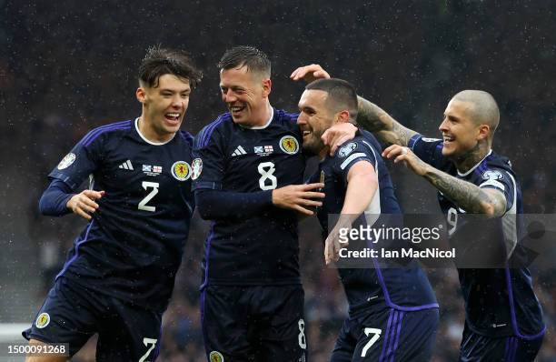 Callum McGregor of Scotland celebrates with teammates Aaron Hickey , John McGinn and Lyndon Dykes after scoring the team's first goal during the UEFA...