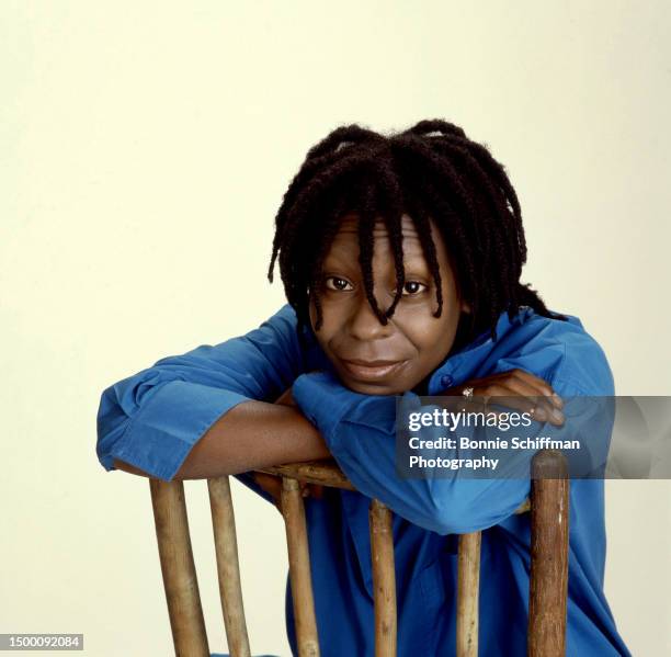 American actress Whoopi Goldberg poses for a portrait sitting in a chair in Los Angeles, California, March 1986.