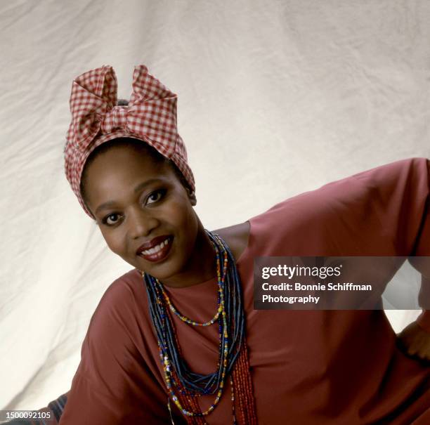 American actress Alfre Woodard poses with necklaces and a bow on her head in Los Angeles, California, circa 1987.