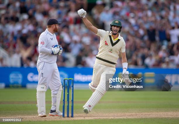 Pat Cummins of Australia celebrates after hitting the winning runs as Jonathan Bairstow of England looks on during Day Five of the LV= Insurance...