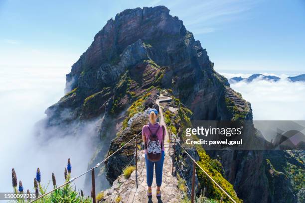 hiker on pr1 pico do arieiro - pico ruivo trail stairway to heaven madeira portugal - pico ruivo stock pictures, royalty-free photos & images