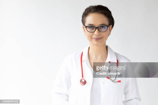 portrait of female doctor - red stethoscope stock pictures, royalty-free photos & images