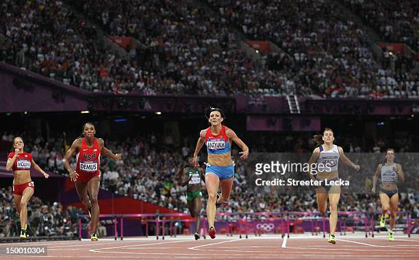 Natalya Antyukh of Russia crosses the finish line ahead of Lashinda Demus of the United States in the Women's 400m Hurdles Final on Day 12 of the...