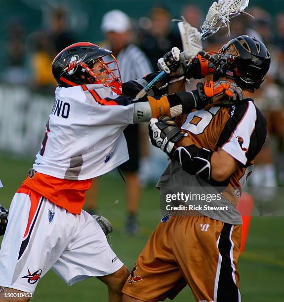 Casey Cittadino of the Denver Outlaws checks Brad Ross of the Rochester Rattlers at Sahlen's Stadium on August 4, 2012 in Rochester, New York. Denver...