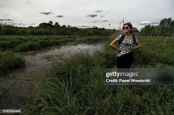 woman standing by oxbow lake of wisla river - oxbow bend stock pictures, royalty-free photos & images