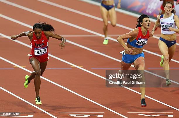 Natalya Antyukh of Russia crosses the finish line ahead of Lashinda Demus of the United States in the Women's 400m Hurdles Final on Day 12 of the...