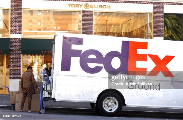 Worker loads packages into a FedEx truck on June 20, 2023 in San Francisco, California. Shipping giant FedEx reported better-than-expected fourth...