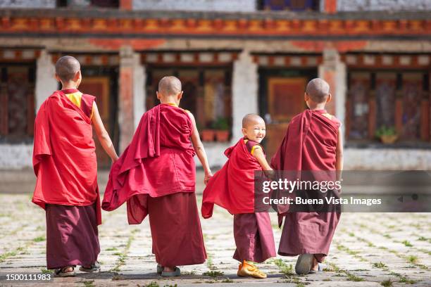 novice buddhist monks in a monastery - bhutan stock pictures, royalty-free photos & images
