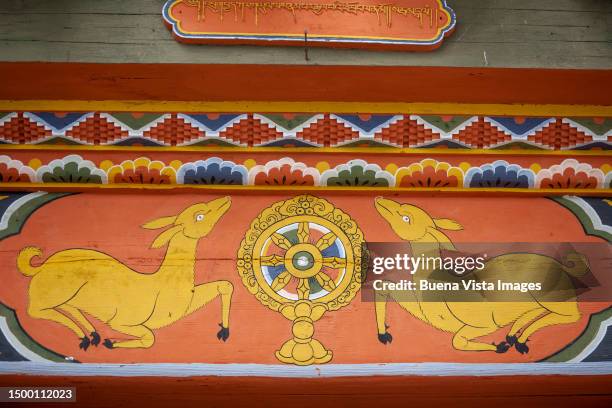 bhutan. dharma wheel painted in a buddhist temple - dharmachakra stock pictures, royalty-free photos & images