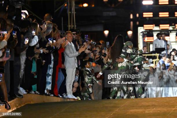 Louis Vuitton Men's Creative Director Pharrell Williams embraces his family, wife Helen Lasichanh and children, after the Louis Vuitton Menswear...