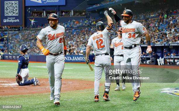 Aaron Hicks of the Baltimore Orioles is congratulated after hitting a three run home run in the second inning during a game against the Tampa Bay...