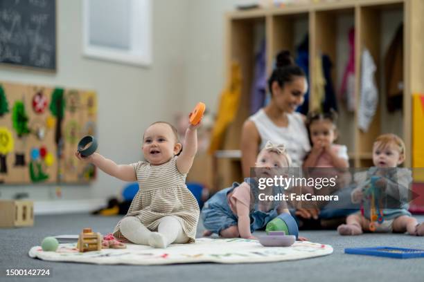 a day at daycare - babies only stock pictures, royalty-free photos & images