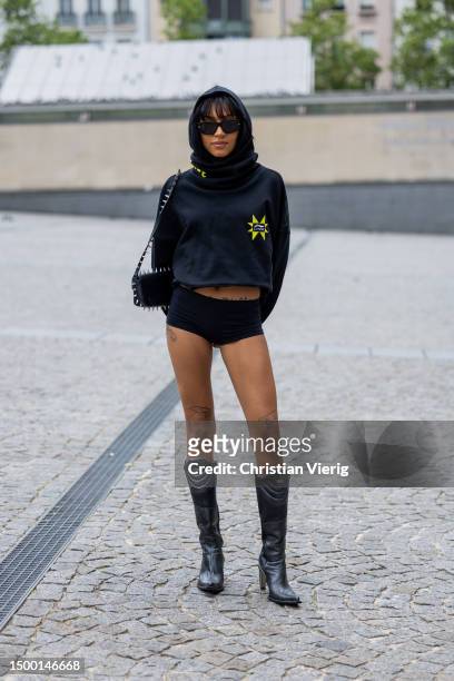 Guest wears hoody, shorts outside Li-Ning during the Menswear Spring/Summer 2024 as part of Paris Fashion Week on June 20, 2023 in Paris, France.