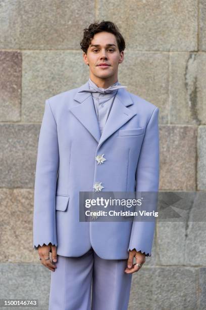 Guest wears lavender suit outside Louis Vuitton during the Menswear Spring/Summer 2024 as part of Paris Fashion Week on June 20, 2023 in Paris,...