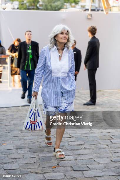 Guest wears blue white button shirt outside Louis Vuitton during the Menswear Spring/Summer 2024 as part of Paris Fashion Week on June 20, 2023 in...