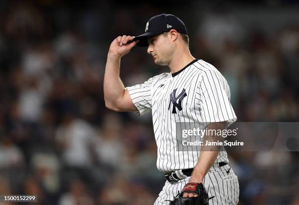 Starting pitcher Gerrit Cole of the New York Yankees tips his hat to a standing ovation by the crowd after leaving the game in the 8th inning against...