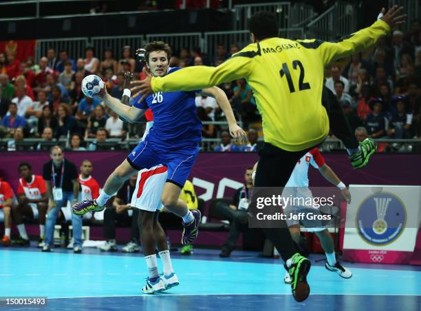 Manuel Strlek of Croatia shoots and scores on goalkeeper Marouen Maggaiz of Tunisia during the Men's Quarterfinal match between Croatia and Tunisia...