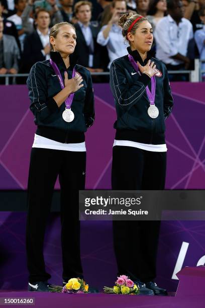 Silver medallists Jennifer Kessy and April Ross of the United States celebrate on the podium during the medal ceremony for the Women's Beach...