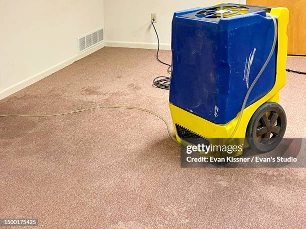 water damaged carpet drying with industrial dehumidifier - damaged carpet stock pictures, royalty-free photos & images