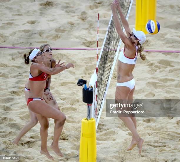 Misty May-Treanor and Kerri Walsh Jennings of the United States return the ball past Jennifer Kessy of the United Staes during the Gold Medal Women's...