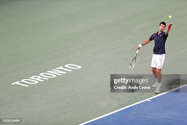 Novak Djokovic of Serbia serves against Bernard Tomic of Australia during the Rogers Cup Presented By National Bank at Rexall Centre at York...