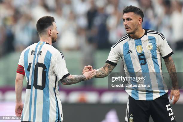 Lionel Messi of Argentina reacts with Leandro Paredes during the international friendly match between Argentina and Australia at Workers Stadium on...