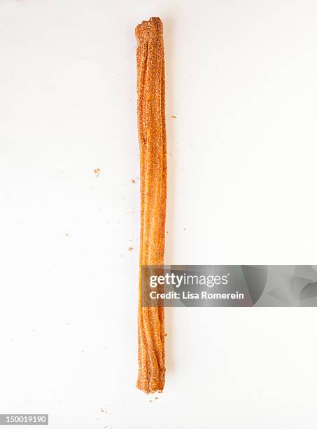 whole cinnamon churro on white - churros stock pictures, royalty-free photos & images