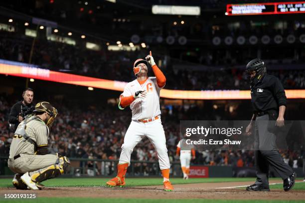 Joc Pederson of the San Francisco Giants reacts at home plate after he hit a home run against the San Diego Padres in the eighth inning at Oracle...