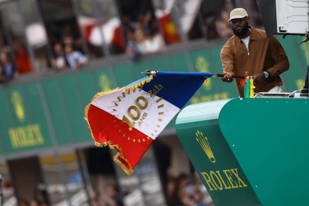 Lebron James holds the starting flag during the 100th anniversary of the 24 Hours of Le Mans at the Circuit de la Sarthe June 10, 2023 in Le Mans,...