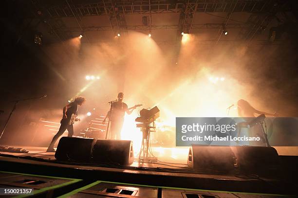 Musicians Yann Gonzalez, Anthony Gonzalez and Morgan Kibby of M83 perform at Central Park SummerStage on August 8, 2012 in New York City.