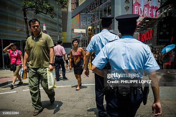 Policemen patrol a street in Hong Kong on August 9, 2012. Hong Kong police said on August 9, 2012 it will go on a trial to use body cameras, in a bid...