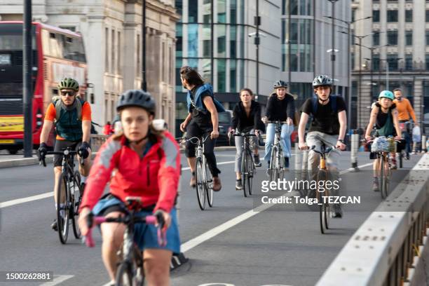 cyclists across london bridge in london, uk - london bikes stock pictures, royalty-free photos & images