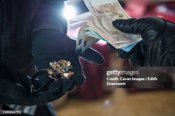 burglars stealing jewelry and euro banknotes - jewelry robbery stock pictures, royalty-free photos & images